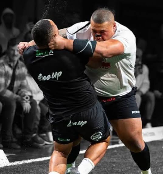 Two athletes collide in a sanctioned collision-sport contest